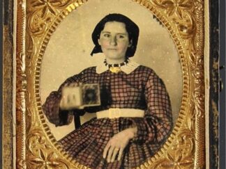 <p class="headtitle">Ambrotype of a young woman holding a cased photograph   1865</p><b>Photographer, Unknown.</b><br />Ambrotype of a young woman holding a cased photograph.